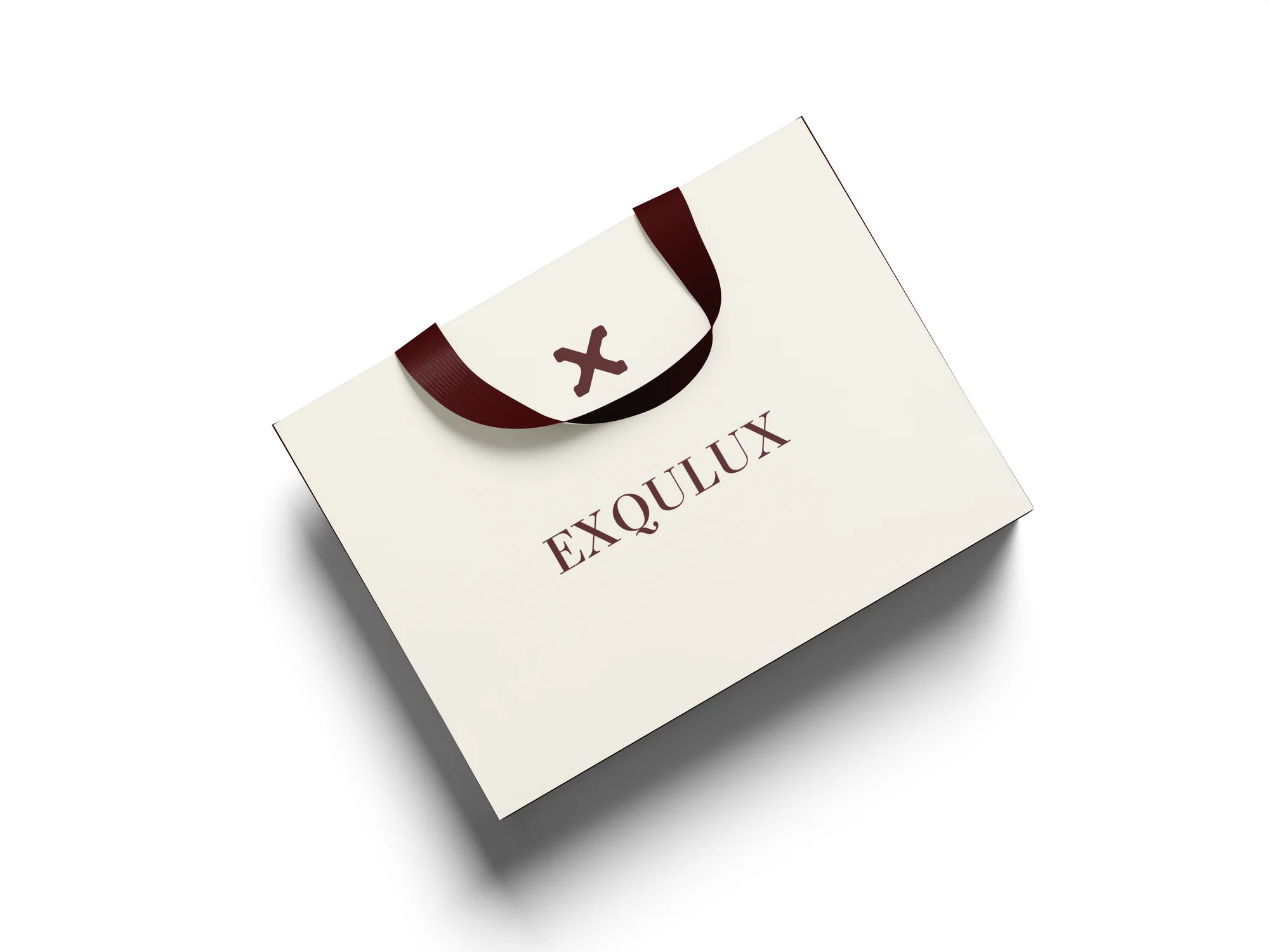 Top-down flat-lay shot of the Exqulux paper bag with the wordmark centred on the face panel